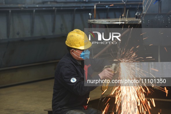 A worker is operating a self-developed water surface cleaning long-arm environmental protection ship at a shipping company's plant in Hangzh...