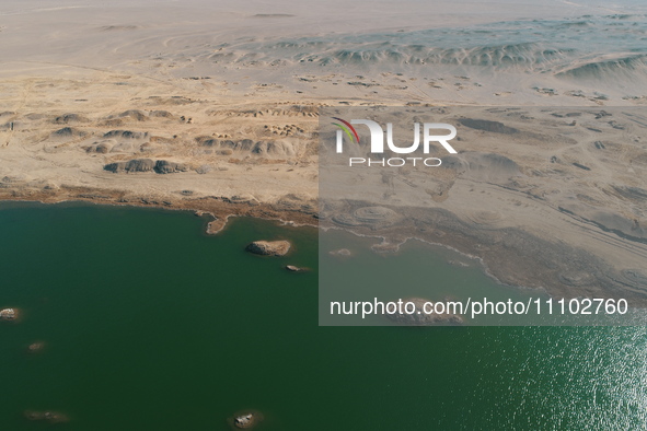 A view of the arid Yadan landscape with a moist lake nestled in the depths of the Gobi desert in Hami, Xinjiang province, China, on March 24...