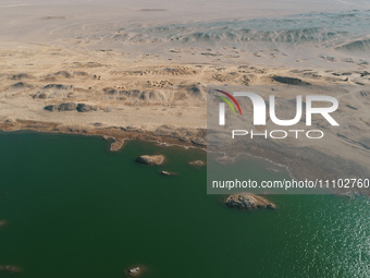 A view of the arid Yadan landscape with a moist lake nestled in the depths of the Gobi desert in Hami, Xinjiang province, China, on March 24...