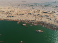 A view of the arid Yadan landscape with a moist lake nestled in the depths of the Gobi desert in Hami, Xinjiang province, China, on March 24...