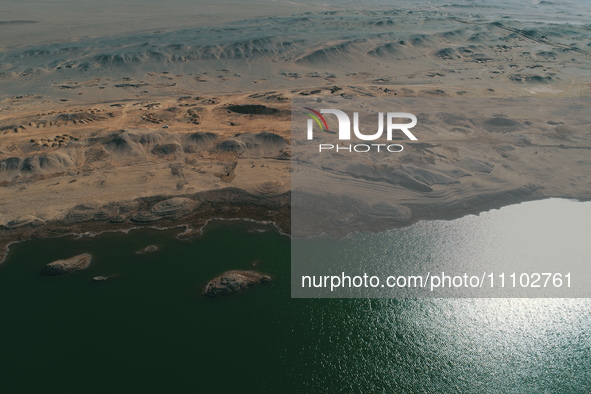 A view of the arid Yadan landscape with a moist lake nestled in the depths of the Gobi desert in Hami, Xinjiang province, China, on March 24...