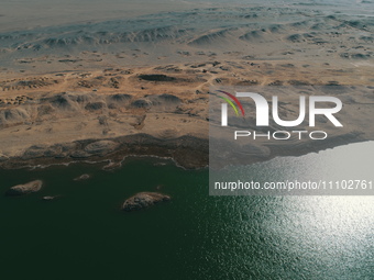 A view of the arid Yadan landscape with a moist lake nestled in the depths of the Gobi desert in Hami, Xinjiang province, China, on March 24...