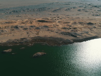 A view of the arid Yadan landscape with a moist lake nestled in the depths of the Gobi desert in Hami, Xinjiang province, China, on March 24...