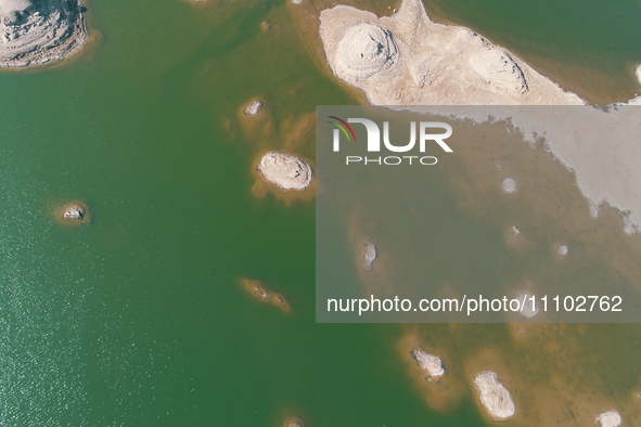 A view of the arid Yadan landscape with a moist lake nestled in the depths of the Gobi desert in Hami, Xinjiang province, China, on March 24...