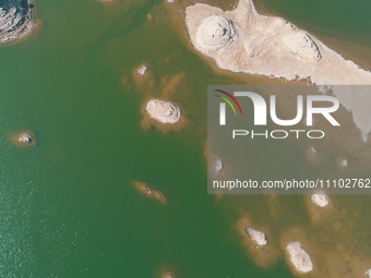 A view of the arid Yadan landscape with a moist lake nestled in the depths of the Gobi desert in Hami, Xinjiang province, China, on March 24...