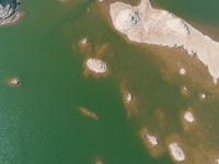 A view of the arid Yadan landscape with a moist lake nestled in the depths of the Gobi desert in Hami, Xinjiang province, China, on March 24...