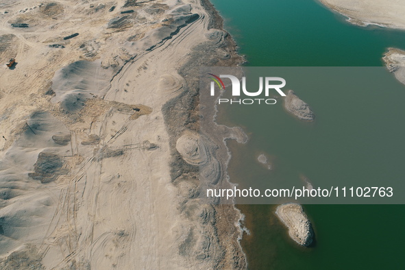 A view of the arid Yadan landscape with a moist lake nestled in the depths of the Gobi desert in Hami, Xinjiang province, China, on March 24...