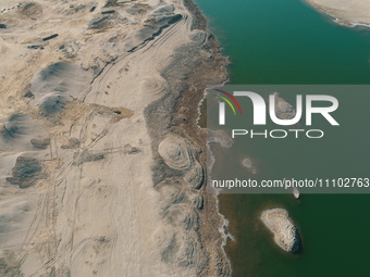 A view of the arid Yadan landscape with a moist lake nestled in the depths of the Gobi desert in Hami, Xinjiang province, China, on March 24...