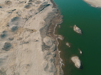 A view of the arid Yadan landscape with a moist lake nestled in the depths of the Gobi desert in Hami, Xinjiang province, China, on March 24...