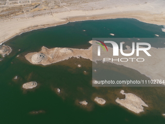 A view of the arid Yadan landscape with a moist lake nestled in the depths of the Gobi desert in Hami, Xinjiang province, China, on March 24...