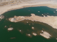 A view of the arid Yadan landscape with a moist lake nestled in the depths of the Gobi desert in Hami, Xinjiang province, China, on March 24...