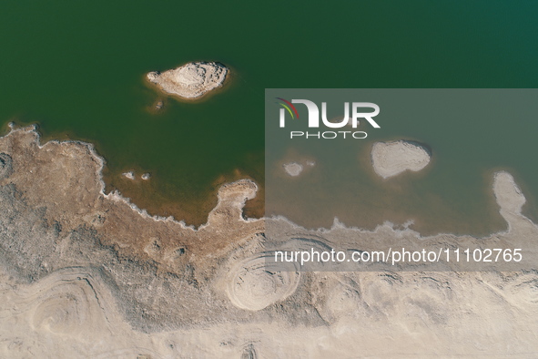 A view of the arid Yadan landscape with a moist lake nestled in the depths of the Gobi desert in Hami, Xinjiang province, China, on March 24...