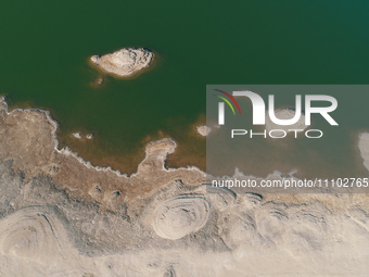 A view of the arid Yadan landscape with a moist lake nestled in the depths of the Gobi desert in Hami, Xinjiang province, China, on March 24...