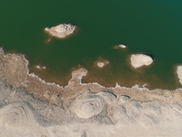 A view of the arid Yadan landscape with a moist lake nestled in the depths of the Gobi desert in Hami, Xinjiang province, China, on March 24...