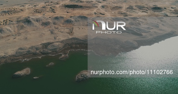 A view of the arid Yadan landscape with a moist lake nestled in the depths of the Gobi desert in Hami, Xinjiang province, China, on March 24...