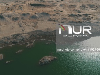 A view of the arid Yadan landscape with a moist lake nestled in the depths of the Gobi desert in Hami, Xinjiang province, China, on March 24...