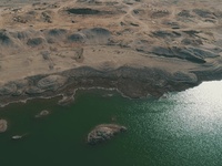 A view of the arid Yadan landscape with a moist lake nestled in the depths of the Gobi desert in Hami, Xinjiang province, China, on March 24...