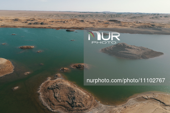 A view of the arid Yadan landscape with a moist lake nestled in the depths of the Gobi desert in Hami, Xinjiang province, China, on March 24...