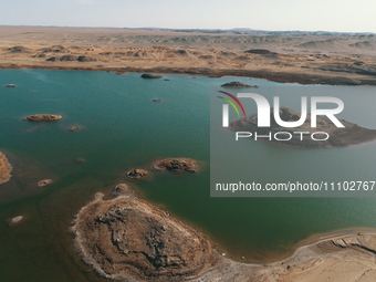 A view of the arid Yadan landscape with a moist lake nestled in the depths of the Gobi desert in Hami, Xinjiang province, China, on March 24...