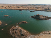 A view of the arid Yadan landscape with a moist lake nestled in the depths of the Gobi desert in Hami, Xinjiang province, China, on March 24...