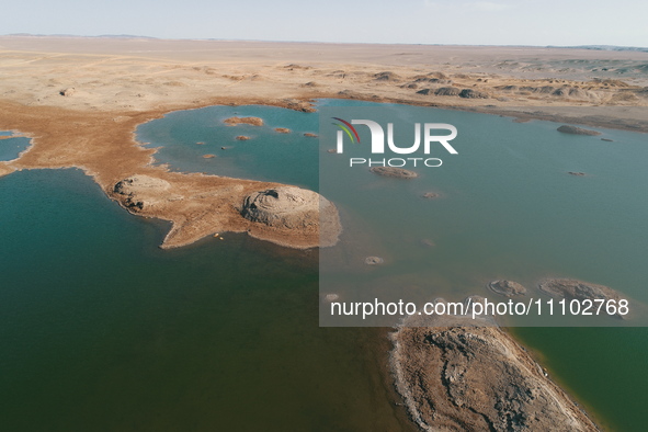 A view of the arid Yadan landscape with a moist lake nestled in the depths of the Gobi desert in Hami, Xinjiang province, China, on March 24...