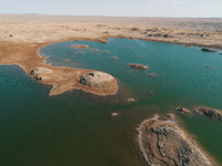 A view of the arid Yadan landscape with a moist lake nestled in the depths of the Gobi desert in Hami, Xinjiang province, China, on March 24...