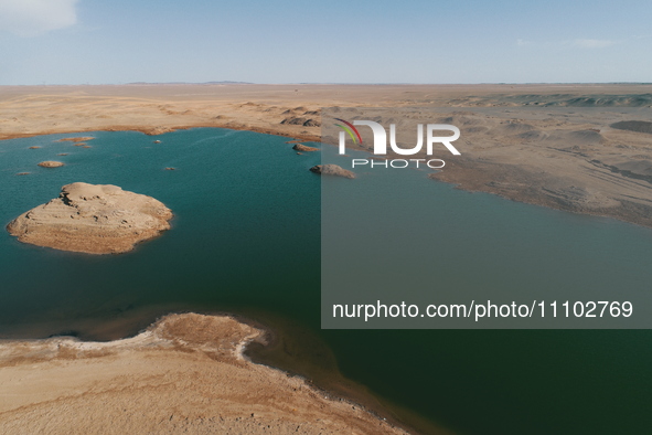 A view of the arid Yadan landscape with a moist lake nestled in the depths of the Gobi desert in Hami, Xinjiang province, China, on March 24...