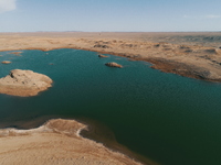 A view of the arid Yadan landscape with a moist lake nestled in the depths of the Gobi desert in Hami, Xinjiang province, China, on March 24...