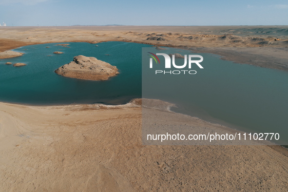 A view of the arid Yadan landscape with a moist lake nestled in the depths of the Gobi desert in Hami, Xinjiang province, China, on March 24...