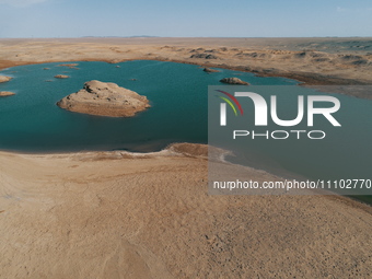 A view of the arid Yadan landscape with a moist lake nestled in the depths of the Gobi desert in Hami, Xinjiang province, China, on March 24...