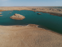 A view of the arid Yadan landscape with a moist lake nestled in the depths of the Gobi desert in Hami, Xinjiang province, China, on March 24...