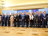 Prime Minister of Poland, Donald Tusk and Prime Minister of Ukraine, Denys Shmyhal (middle) pose with their cabinets for a family photo as U...