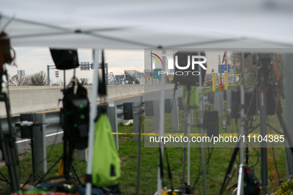 The collapsed Francis Scott Key Bridge is seen through a media staging area at the Maryland Tansportation Authority headquarters in Dundalk,...