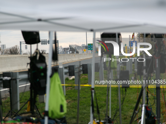 The collapsed Francis Scott Key Bridge is seen through a media staging area at the Maryland Tansportation Authority headquarters in Dundalk,...