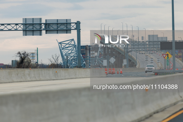 The collapsed Francis Scott Key Bridge is seen from a media staging area at the Maryland Tansportation Authority headquarters in Dundalk, Ma...