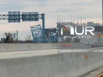 The collapsed Francis Scott Key Bridge is seen from a media staging area at the Maryland Tansportation Authority headquarters in Dundalk, Ma...