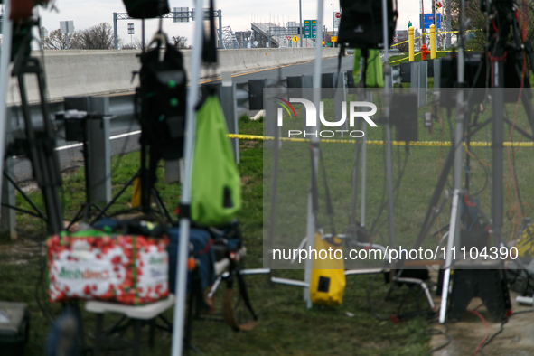 The collapsed Francis Scott Key Bridge is seen through a media staging area at the Maryland Tansportation Authority headquarters in Dundalk,...