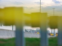 The collapsed Francis Scott Key Bridge is seen beyond police tape at a media staging area at the Maryland Tansportation Authority headquarte...