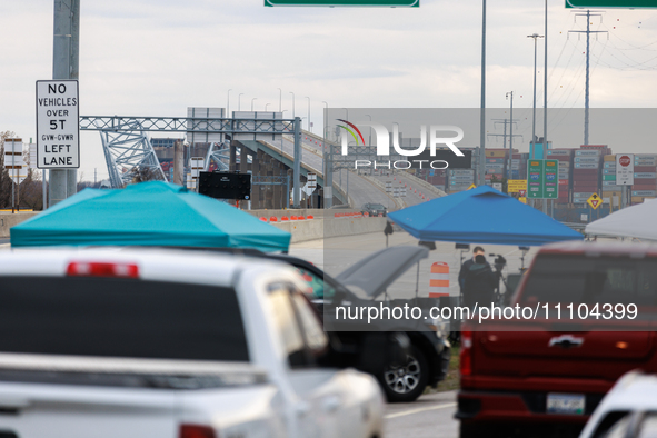 The collapsed Francis Scott Key Bridge is seen from a media staging area at the Maryland Tansportation Authority headquarters in Dundalk, Ma...