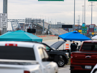 The collapsed Francis Scott Key Bridge is seen from a media staging area at the Maryland Tansportation Authority headquarters in Dundalk, Ma...