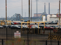 The collapsed Francis Scott Key Bridge is seen beyond the Dundalk Marine Terminal in Dundalk, Maryland on March 28, 2024. (