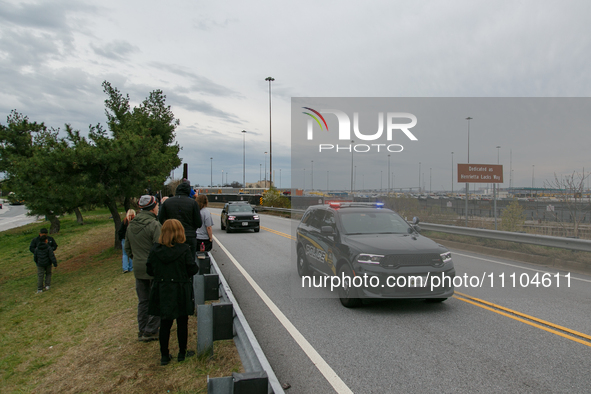 People view the collapsed Francis Scott Key Bridge from the side of Broening Highway in Dundalk, Maryland on March 28, 2024. 