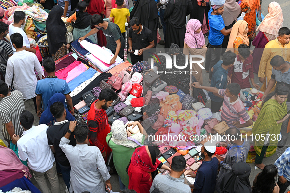 Bangladeshi Muslim people busy shopping at New Market ahead of the Eid al-Fitr festival, during the holy month of Ramadan in Dhaka, Banglade...