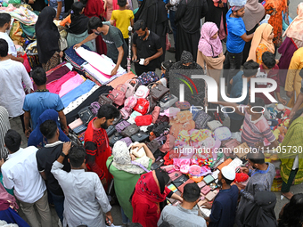 Bangladeshi Muslim people busy shopping at New Market ahead of the Eid al-Fitr festival, during the holy month of Ramadan in Dhaka, Banglade...