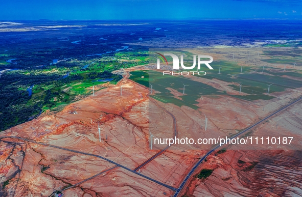 Wind power facilities are seen in Xinjiang, China, on July 14, 2019. Xinjiang is integrating wind, solar, hydro, biomass, geothermal, and na...