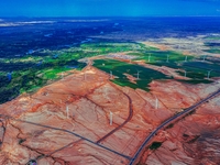 Wind power facilities are seen in Xinjiang, China, on July 14, 2019. Xinjiang is integrating wind, solar, hydro, biomass, geothermal, and na...