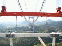 Workers are working at the construction site of Jinzhou Bridge in Xingyi, China, on March 31, 2024. (