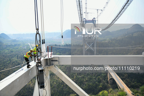 Workers are working at the construction site of Jinzhou Bridge in Xingyi, China, on March 31, 2024. 