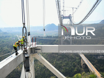 Workers are working at the construction site of Jinzhou Bridge in Xingyi, China, on March 31, 2024. (