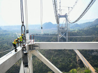 Workers are working at the construction site of Jinzhou Bridge in Xingyi, China, on March 31, 2024. (